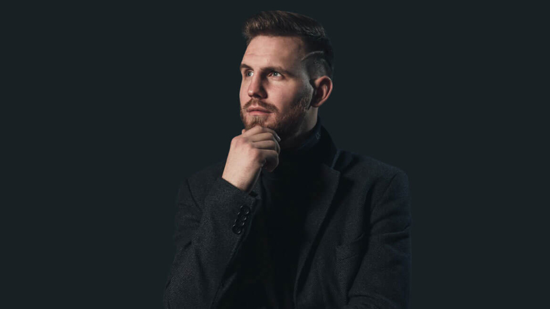 man in black suit jacket full width 1